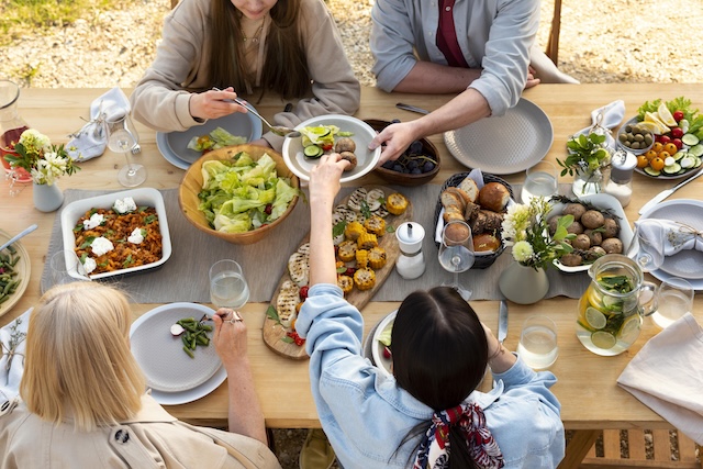 guests sharing food at a potluck with eco friendly serve ware